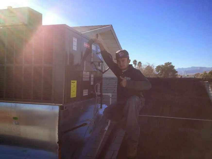 HVAC technician performing Heat Pump Repair on a rooftop unit in Hagerstown